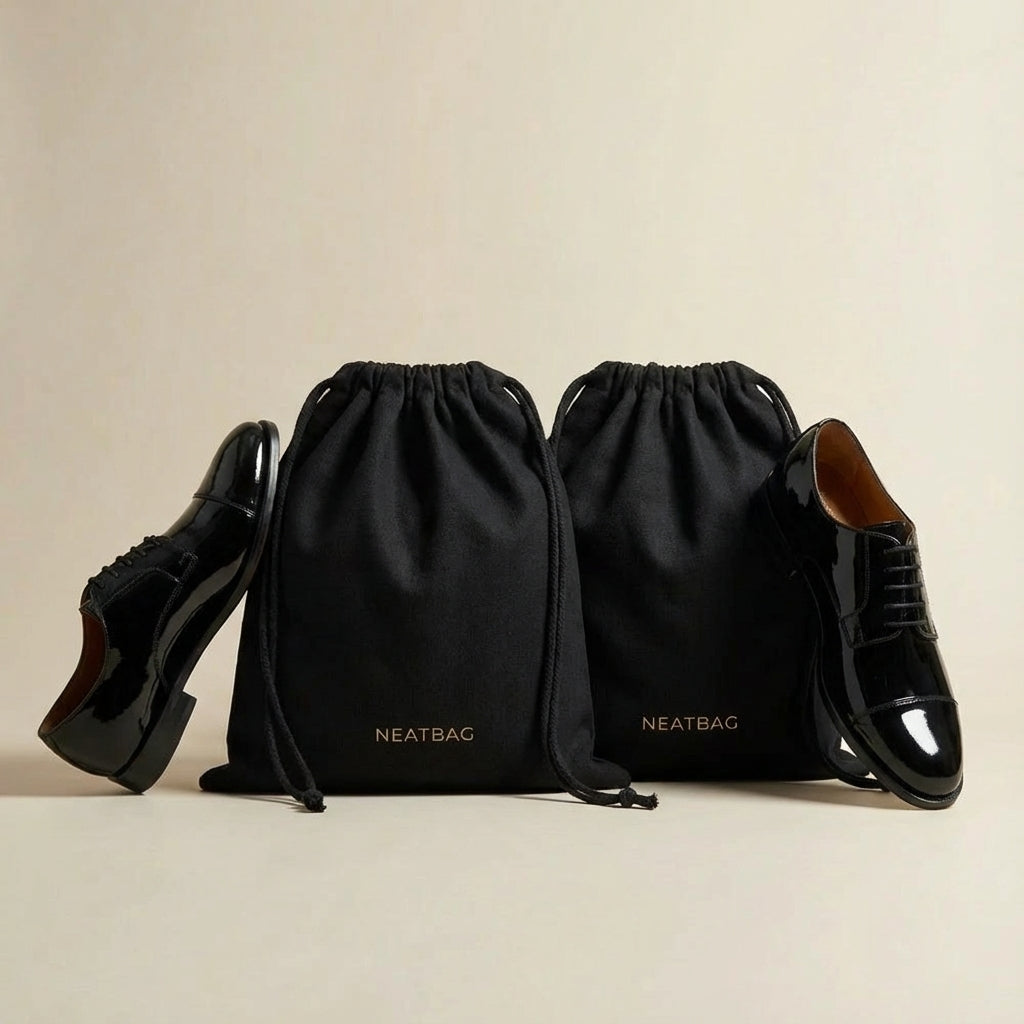 Black drawstring bags with shoes on a beige background, featuring the brand 'NEATBAG'.